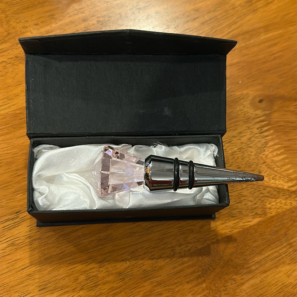 Pink round brilliant cut crystal wine stopper. Black and silver stopper.